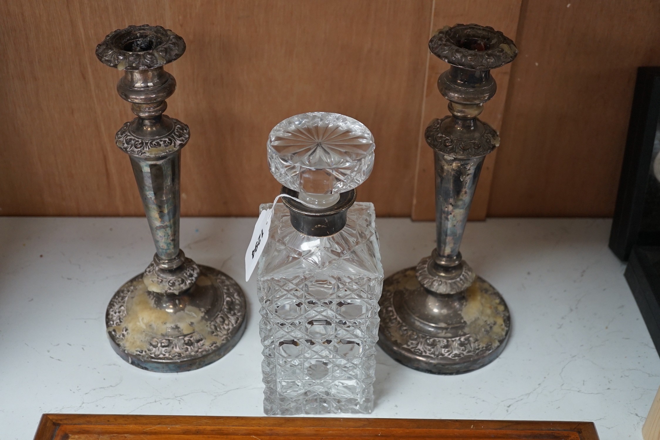A silver mounted spirit decanter, a pair of plated candlesticks and canteen box, decanter 24 cms high